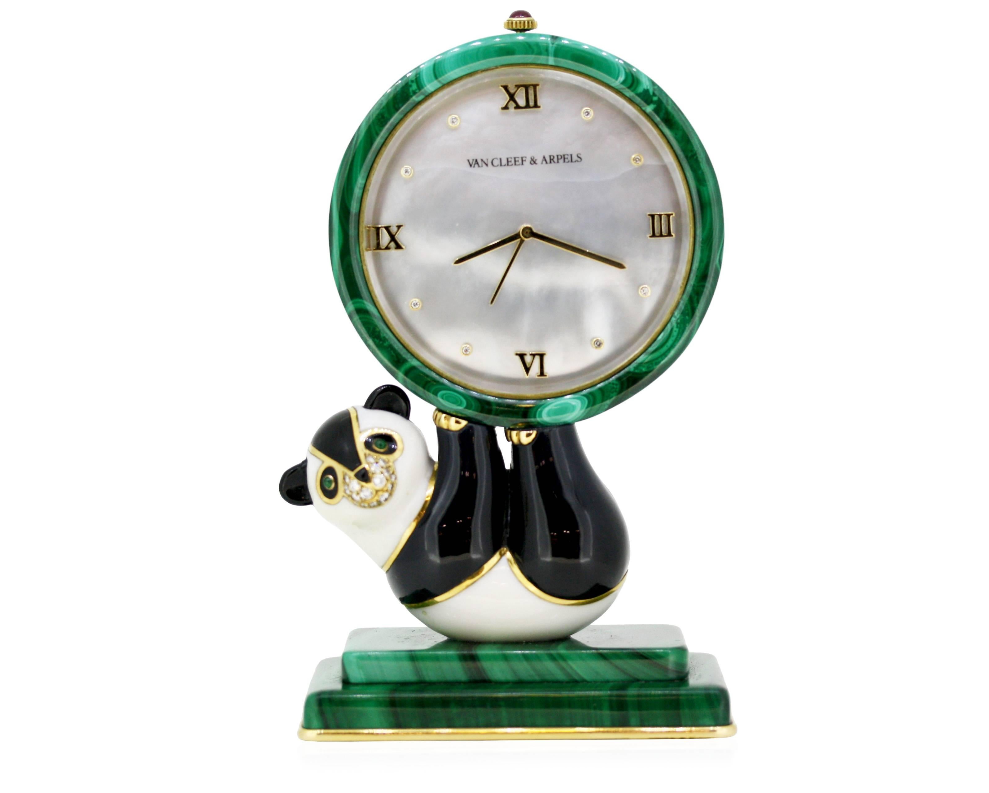The playful panda formed of onyx and white hardstone with cabochon emerald eyes and pavé-set diamond muzzle, lying on his back while balancing a 'ball' featuring a mother-of-pearl dial and gilt Roman numerals alternating with single-cut diamonds