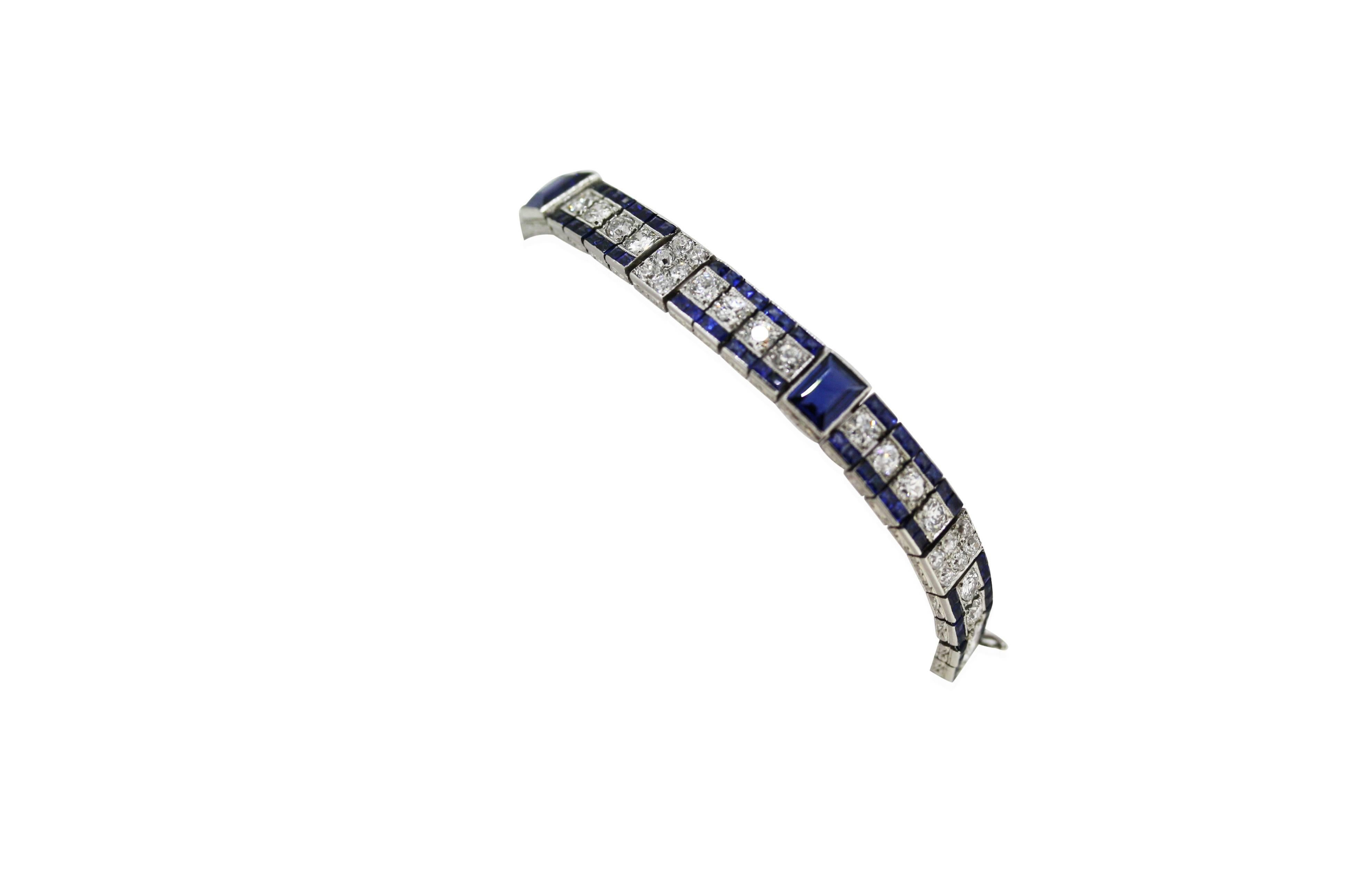 The highly articulated bracelet set with a row of old-cut diamonds, spaced by alternating links set with a large blue sapphire and the other set with small diamonds, flanked by a row of square-cut pavé set sapphires. Mounted in platinum

Diamonds