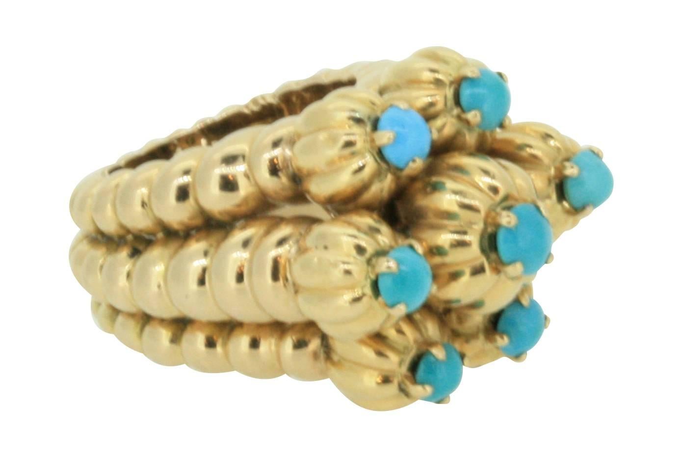 Of bold sculptural design, shaped as a crown, set with seven round cabouchon-cut turquoise
Signed Mauboussin