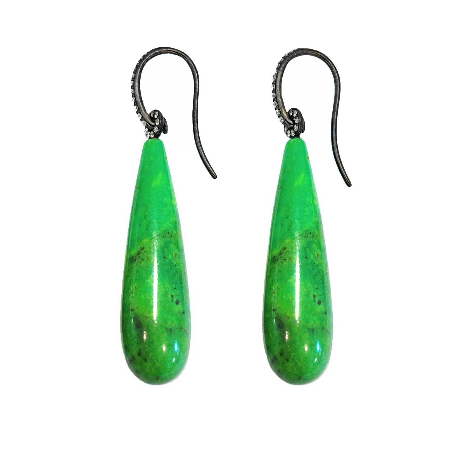 These vibrant green nevada turquoise 42.5 ct earrings will catch one’s eye.
18K white gold black-rhodium-plated with 38 brilliant-cut diamonds and a length of 48.5 mm. At the widest point they are 10 mm.
Designed by Colleen B. Rosenblat 
