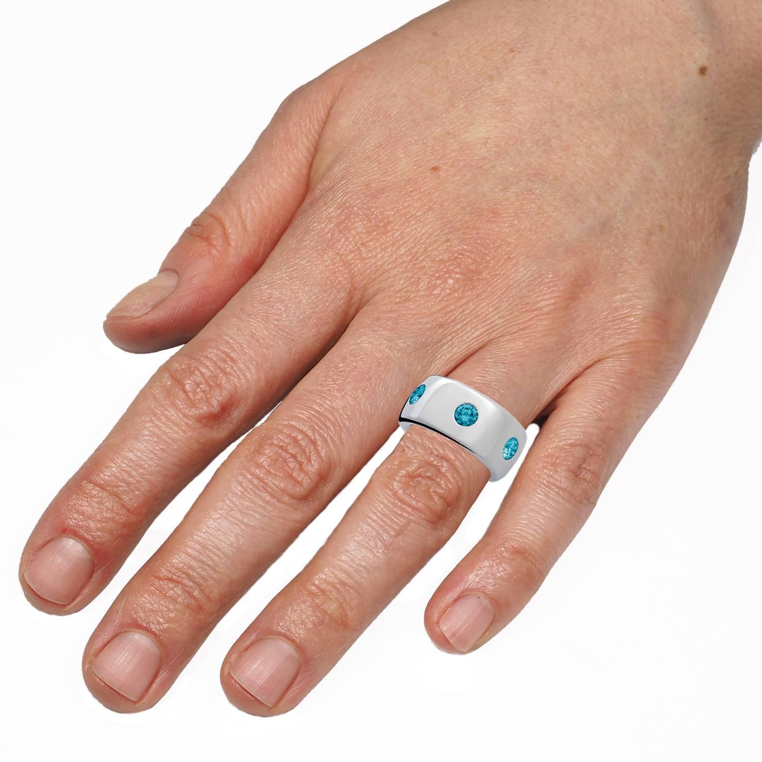 Handmade contemporary Ring with 6 beaming blue diamonds set in 18 carats white gold.