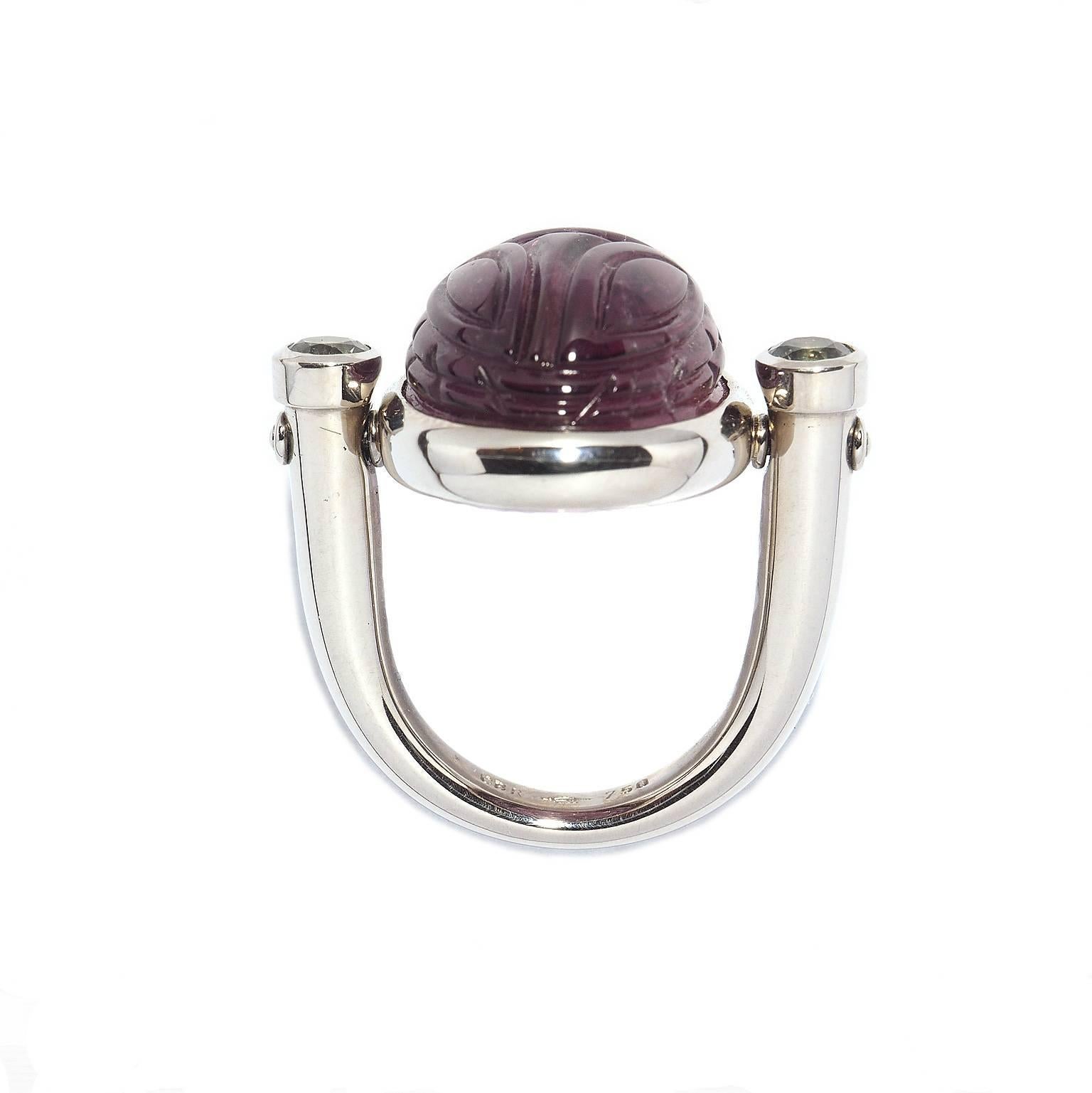 In old Egypt the scarab was a symbol for resurrection and life and since that time a lucky charm for everyone. This desirable ring in size 57 with one rubellite 22.44 ct and two sapphires 0.68 ct could be your personal lucky charm!
The middle part