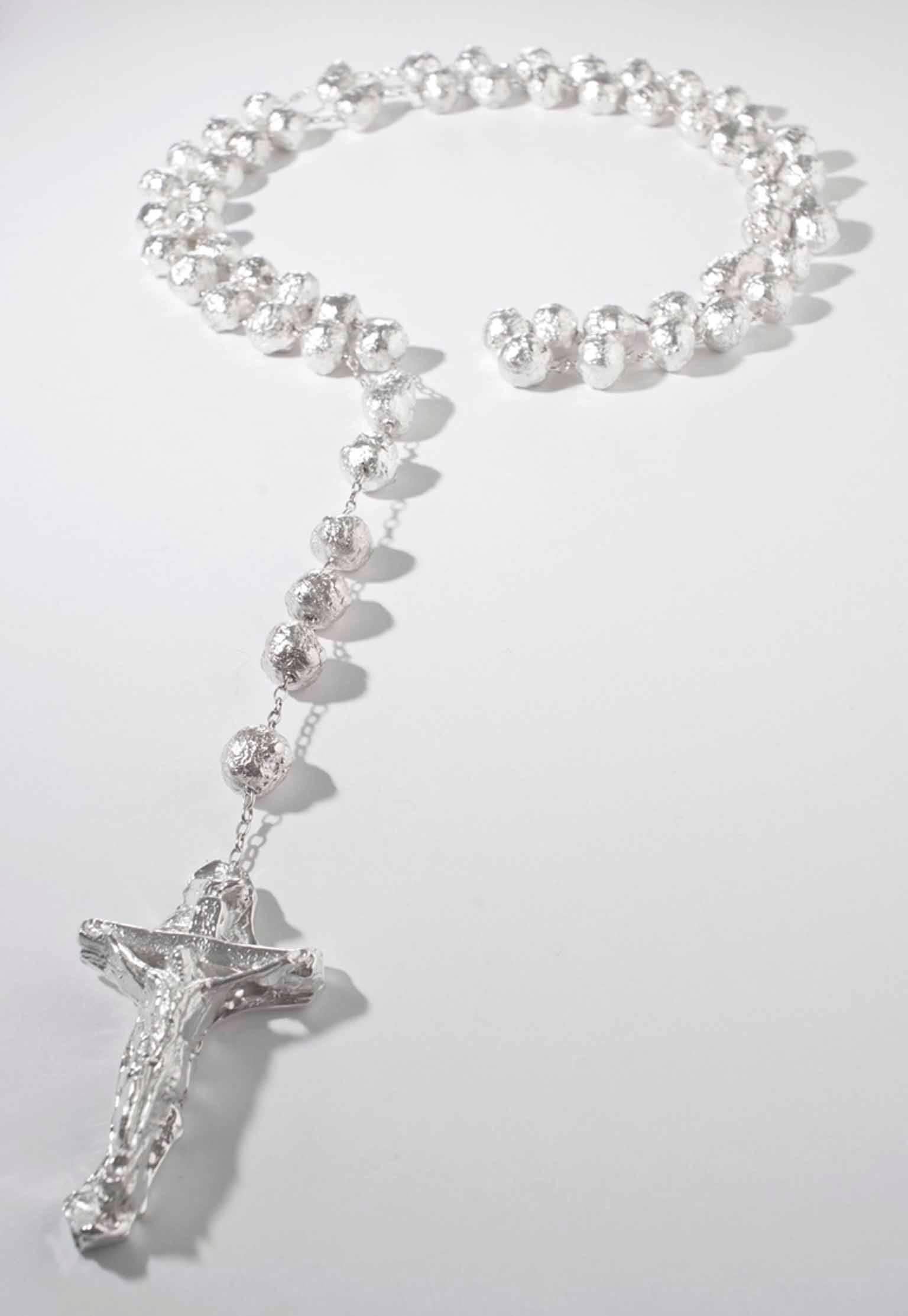 Silver Necklace/ Rosary
edition of 5

The 2011 collaboration between Kendell Geers and Elisabetta Cipriani Gallery resulted in three different iconic pieces that convey the characteristic intensity of the artist’s works. Speaking in Tongues