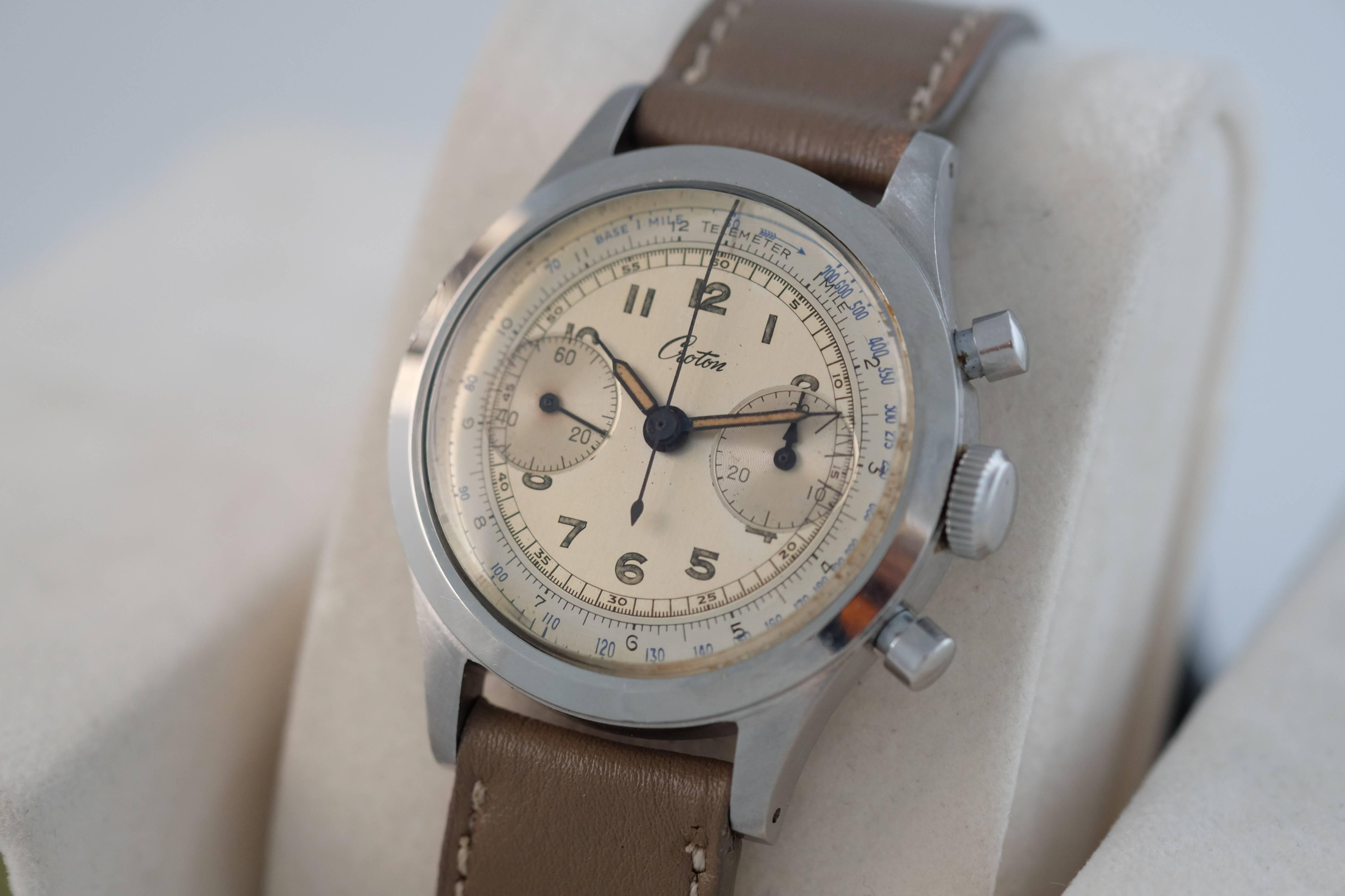 Croton. A Stainless Steel Clamshell Chronograph with Tachometer and Telemeter Scales

Case No: 886xxx

Circa: 1950’s

Mechanical jeweled movement, two-tone silvered dial, luminous Arabic numerals, luminous hands, railway minute divisions,