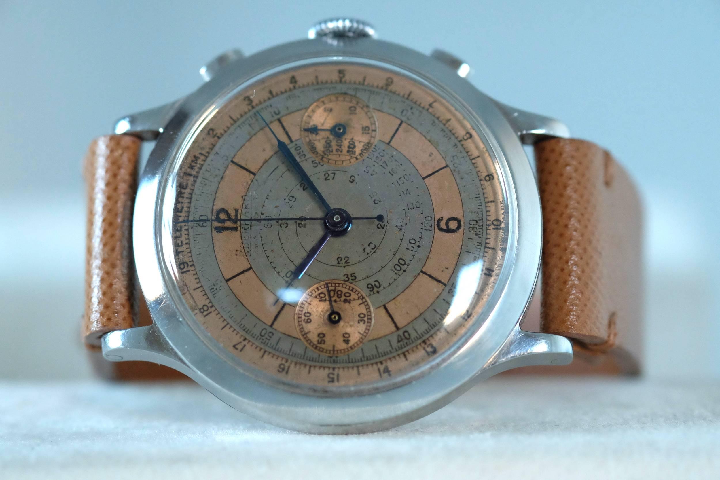 A very large Stainless Steel Double pusher Chronograph from Eberhard

Case. Three-body, polished, stepped flat bezel, concave lugs, flat band, hinged snap-on case back.

Dial. Two -Tone Salmon and grey colored dial with baton indexes and Arabic