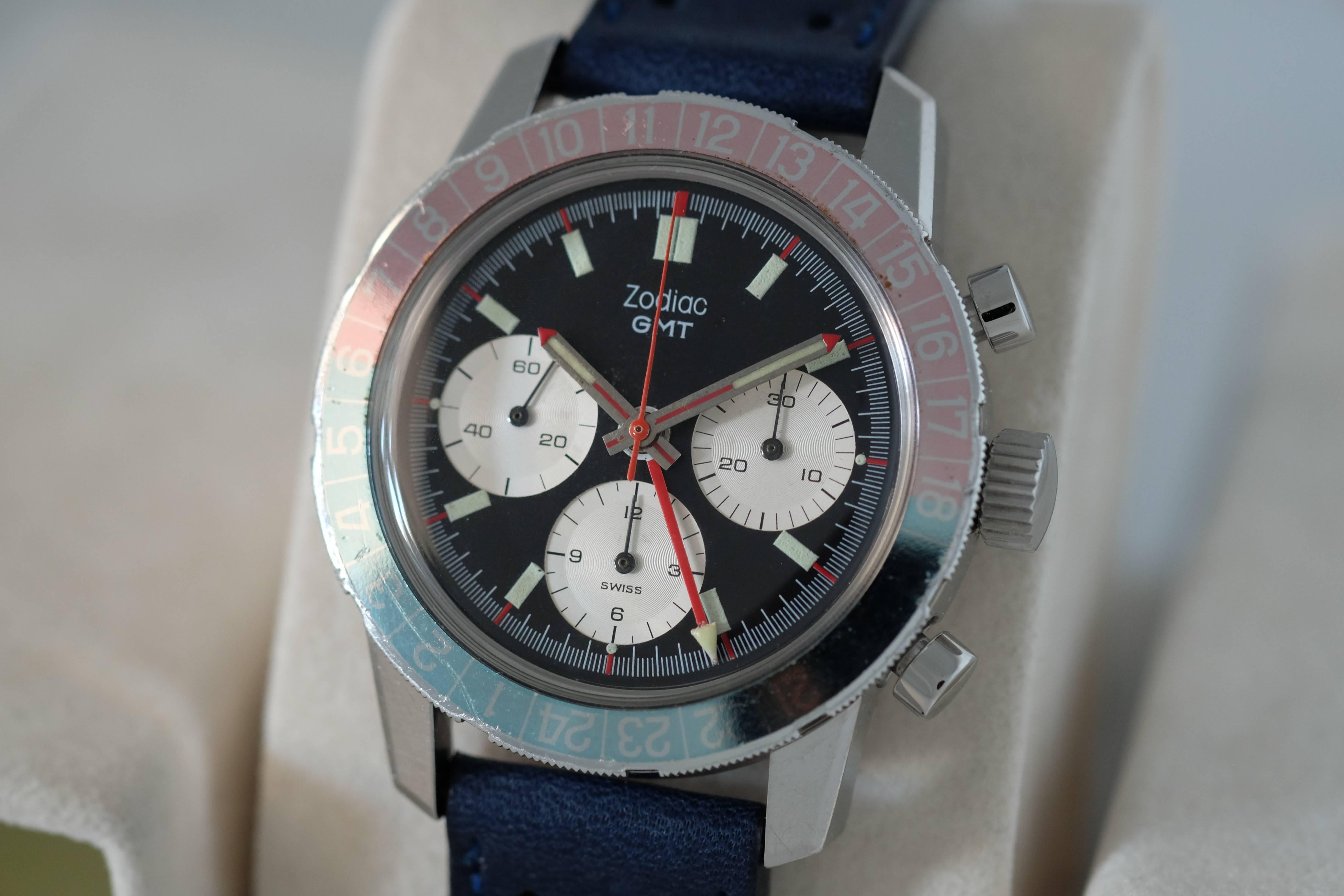 Zodiac. A Stainless Steel GMT Chronograph Wristwatch

Circa: 1970

Valjoux 724 mechanical jeweled movement, matte black dial, luminous baton numerals with outer red accents, luminous hands with red tips and accents, outer minute divisions,