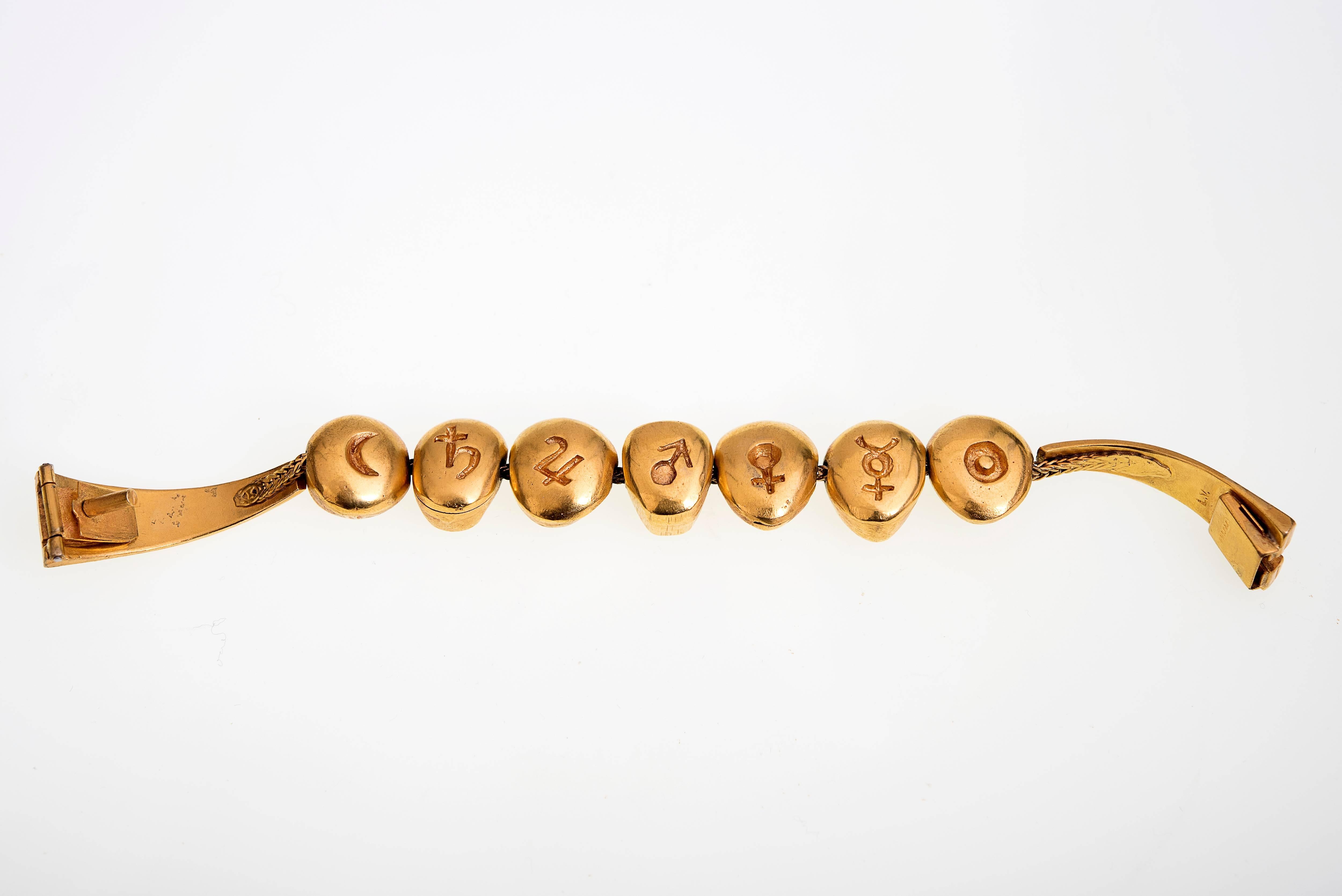 A rare poetic gilded bronze bracelet by French artist Line Vautrin featuring elements with one side a series of faces; the other side symbols of planets : Moon, Saturn, Jupiter, Mars, Venus, Mercure, Sun
ca 1950