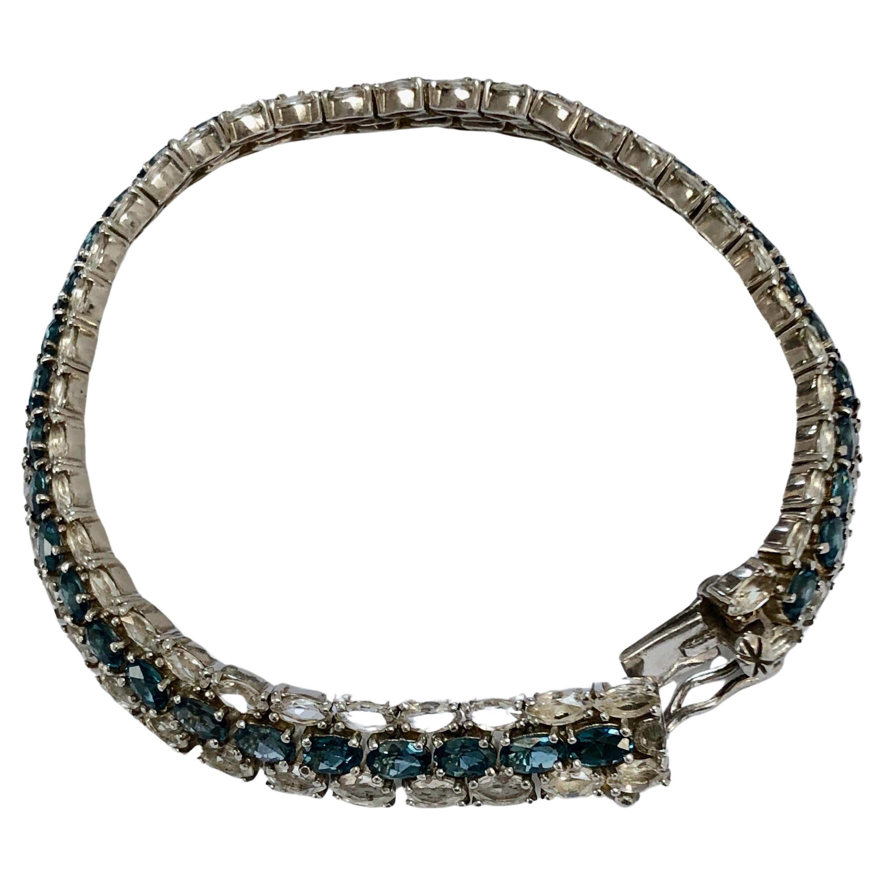 Stunning hand made large bracelet. Natural blue and white topaz mounted in sterling silver three line, link bracelet. Total length 8.20 inches and 0.39 inch wide. About 29.38 grams. 