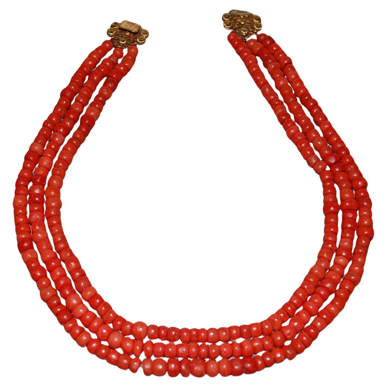A Three Strand Red Coral Necklace Gold Clasp  For Sale