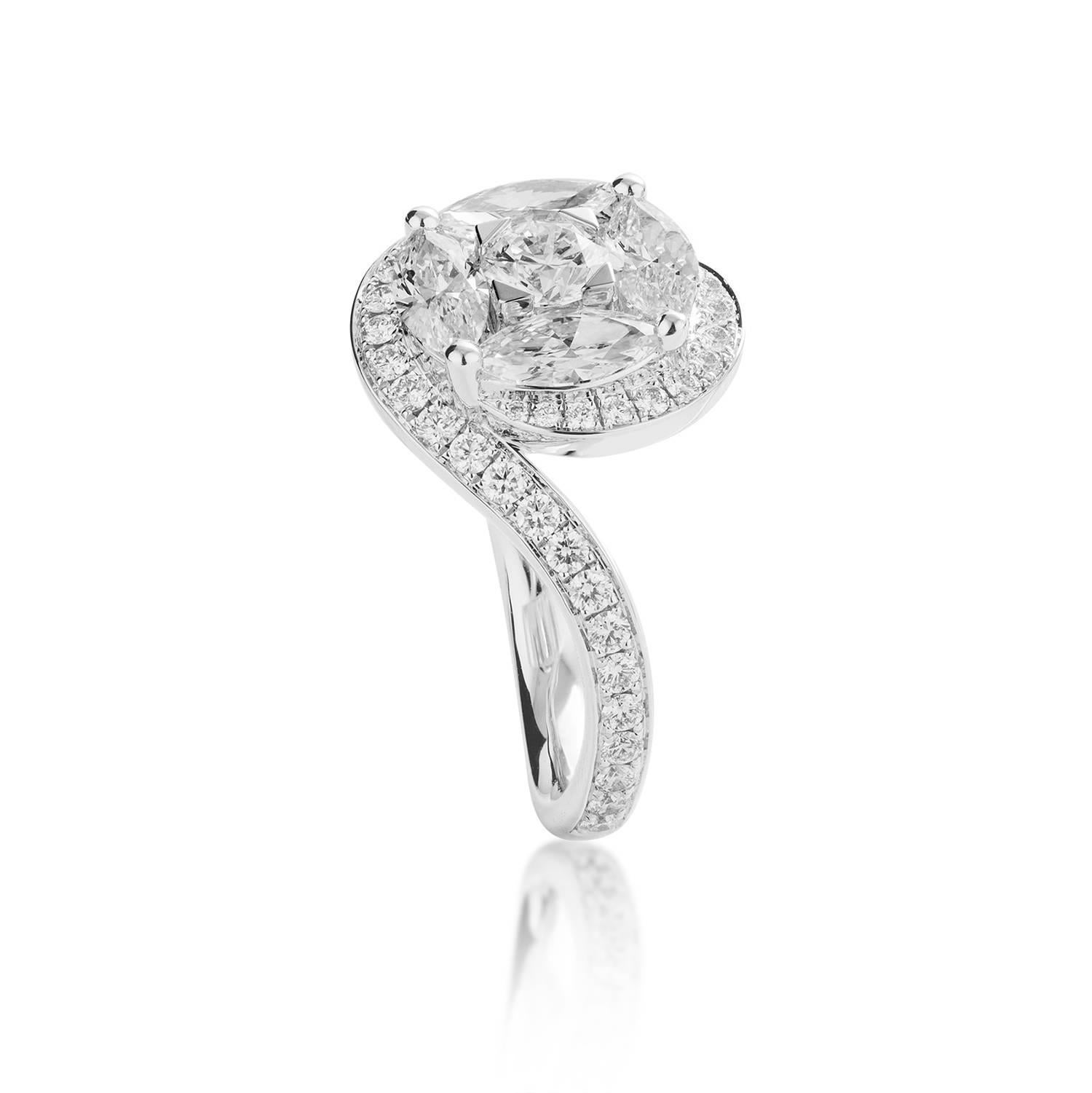 Marquise cut diamonds (0.98ct) and a round brilliant cut diamond (0.32ct) are cleverly set to give the illusion of one large diamond.  Surrounded by brilliant cut diamonds on the face of the ring and 3/4s of the band, with a total carat weight of