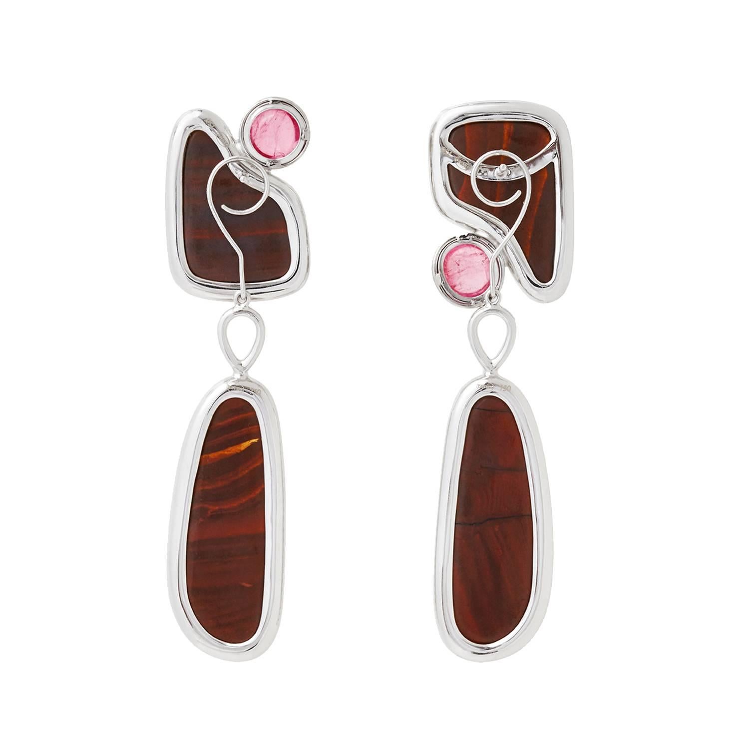 This pair of artistic Bushfire opal earrings accented with cabochon Rubellites and diamonds would make a perfect conversation pieces. The earrings are interchangeable for an easy switch from office to gala.

Gemstone information: 
4 Opals