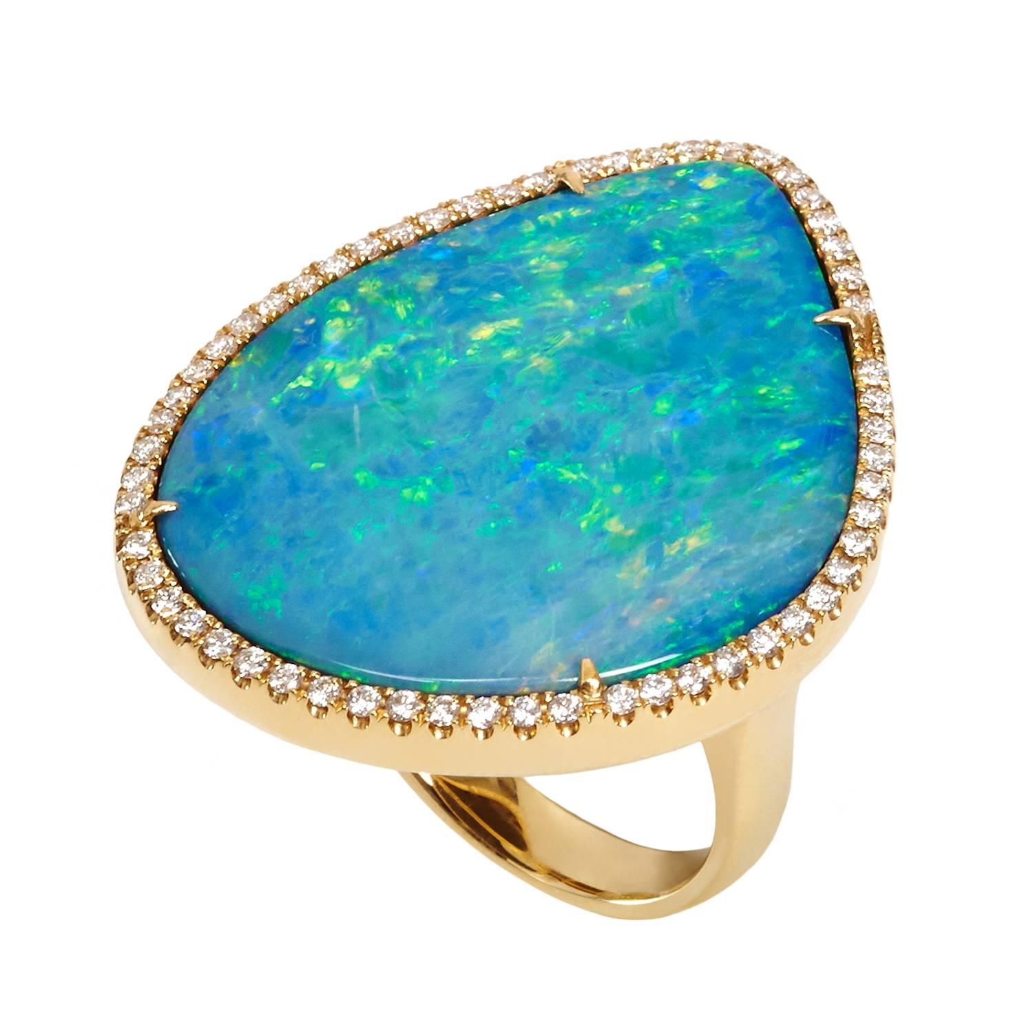 Dramatic opal ring, hand made, one of a kind with micro set diamonds. Flashes of turquoise and yellow - it looks like Monet's garden. Matching drop earrings and pendant available, please enquire.

Gemstone weight:
1 Australian boulder backed