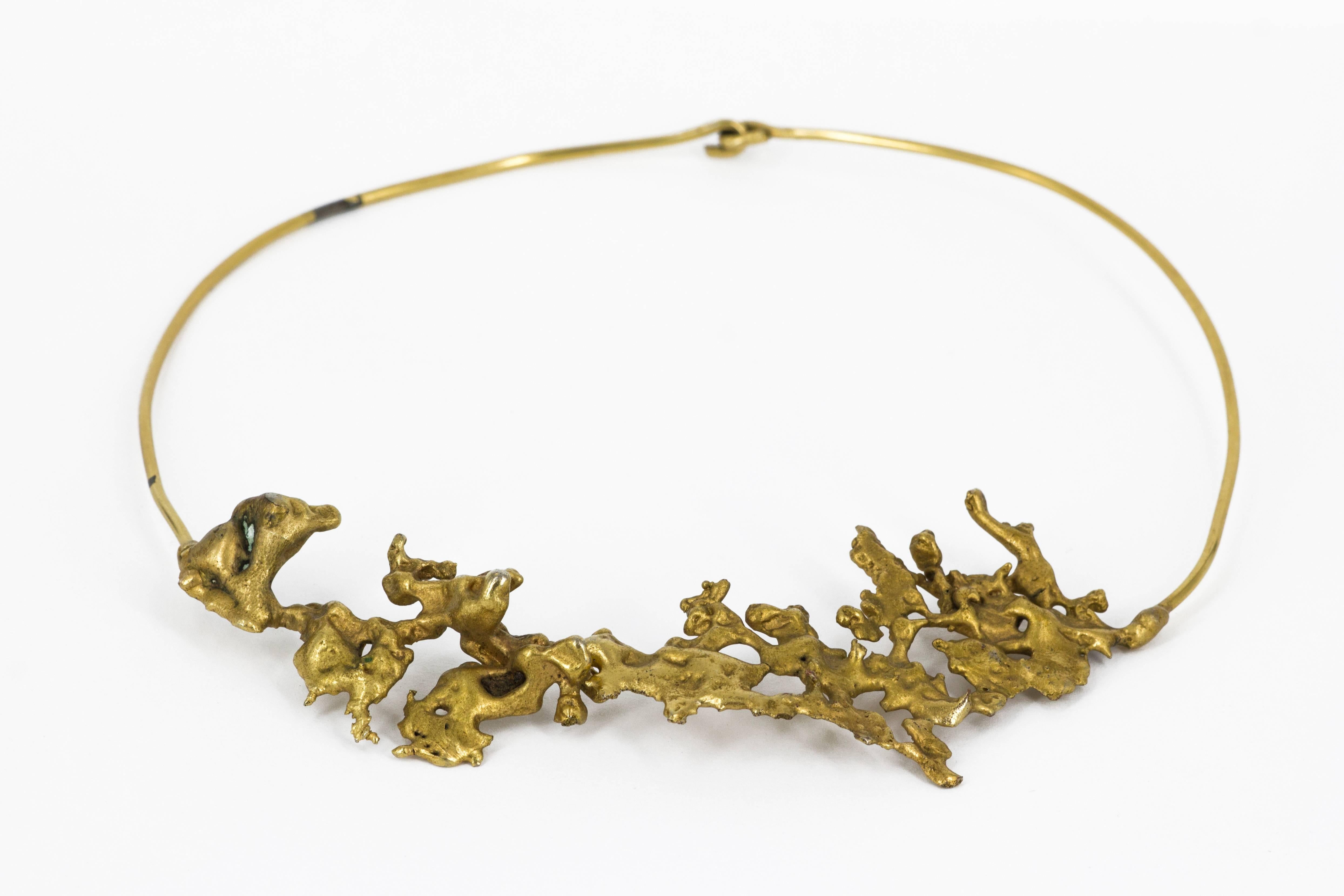Extraordinary necklace with organic shapes realized by the Italian artist Nino Franchina (1912 - 1985) in 1966. Cast and gold plated metal. Unique piece.