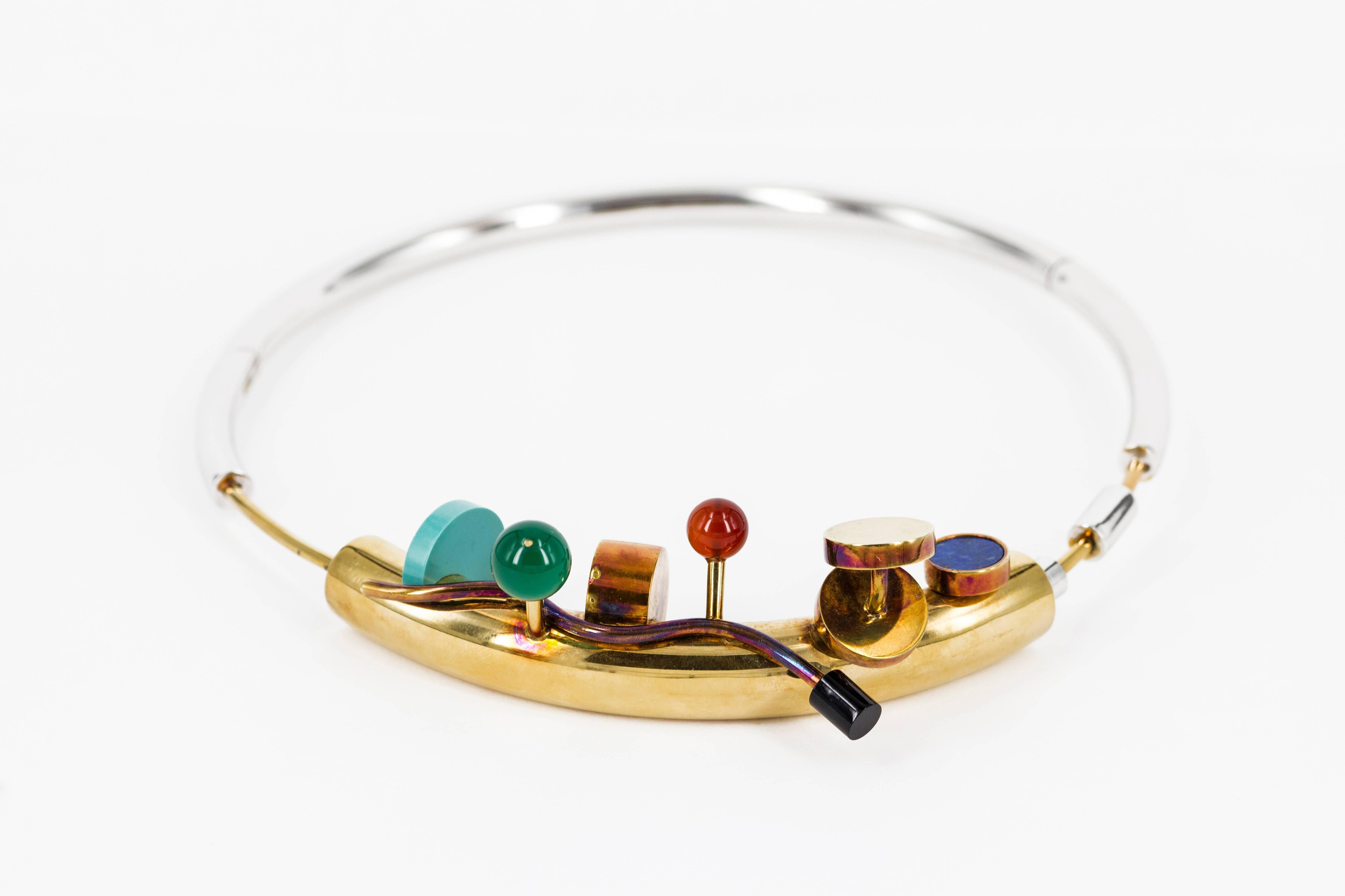 Extraordinary necklace prototype designed by Ettore Sottsass for Cleto Munari in 1984. Chrome and gold plated collar, turquoise, black onyx, green and red agate, lapis lazuli. Unique piece.