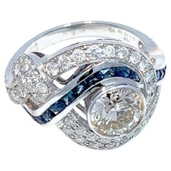 18K White Gold swirling Blue Sapphire and Natural Diamond Ring