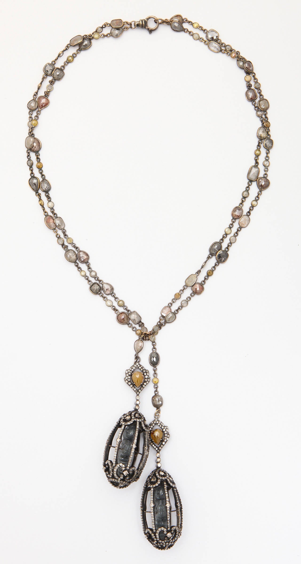 A necklace composed of a rhodium plated 18kt yellow gold and fancy rose cut diamond chain and two rhodium plated sterling silver birdcages. The birdcages are set with diamonds and have jade birds perched inside. The necklace has a total of 45.34cts