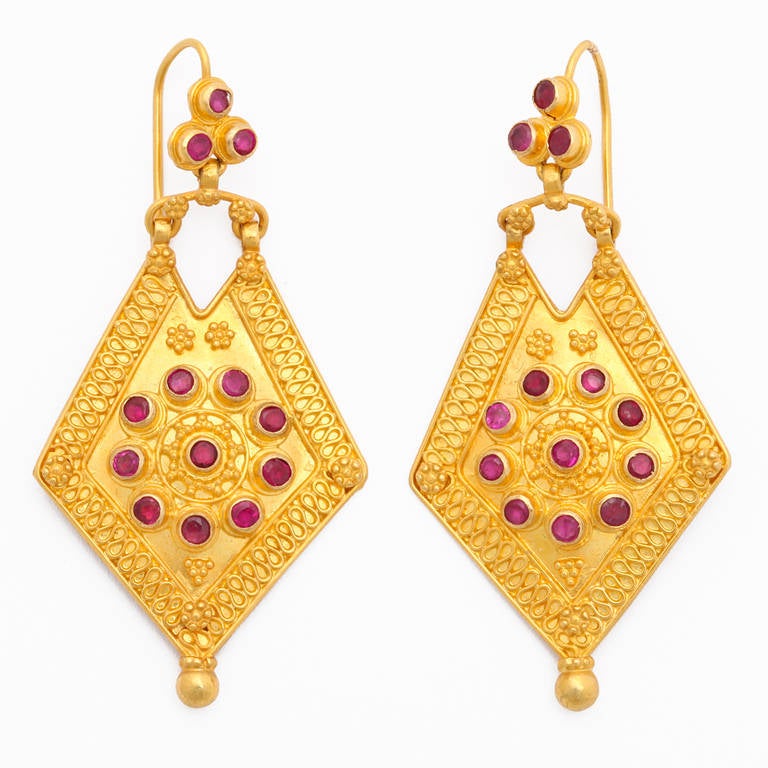 A pair of 18kt yellow gold and ruby earrings. There are approximately 1.82cts of rubies.