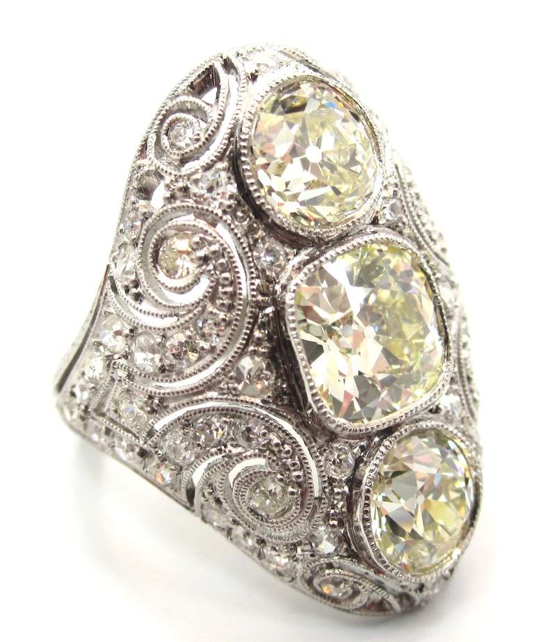 A fine example of Edwardian era craftsmanship. Composed of platinum with an intricate pierced open work & filigree design throughout. Accompanied by a Professional Gem Sciences Laboratory (P.G.S) Diamond Report stating that the ring features a