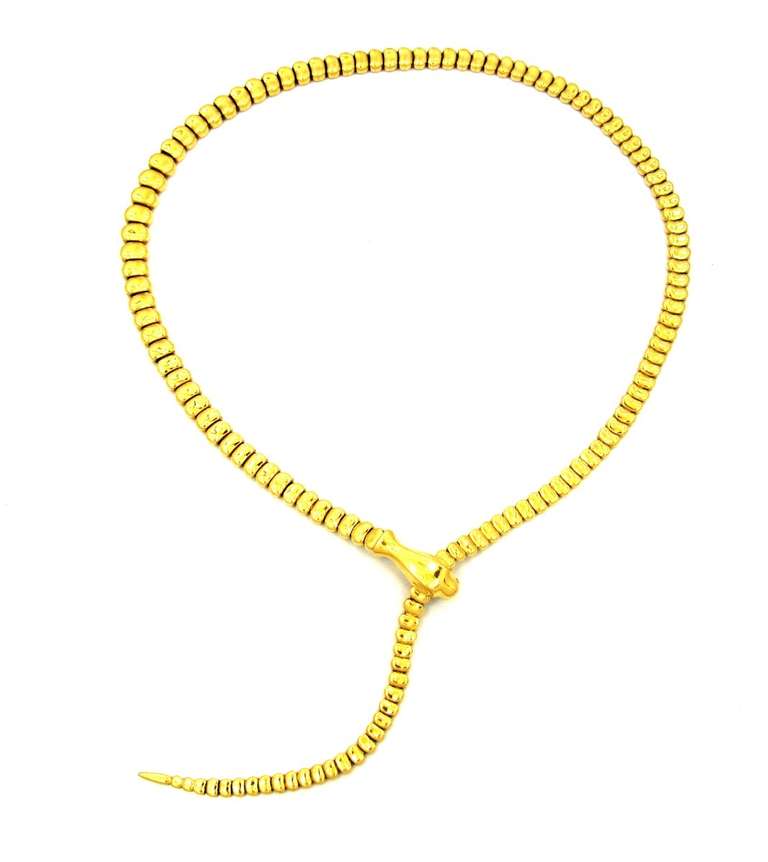 Composed of solid 18 karat yellow gold. Flexible snake motif design. The head of the snake acts as a clasp that opens up and allows the necklace to slide through and be worn at different lengths.

Weighing 76.0 Grams.
Measuring 19.5 Inches in