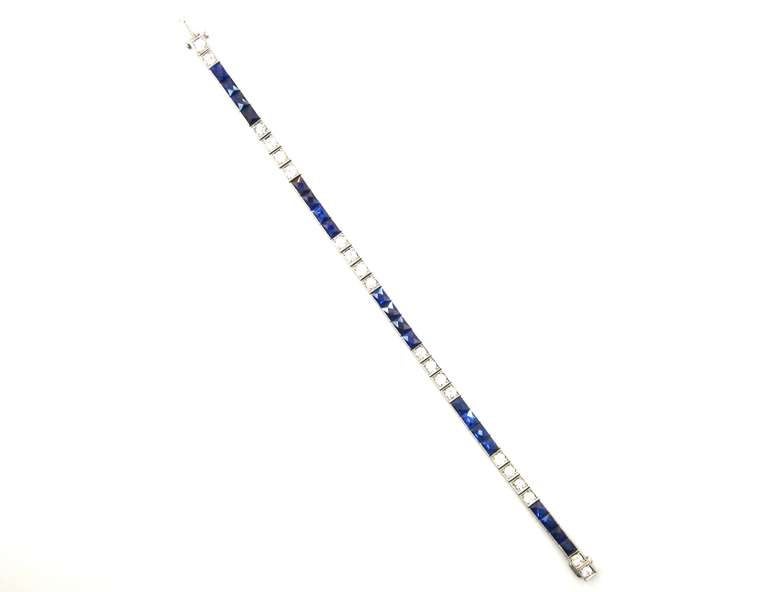 One of the finest examples of an Art Deco era sapphire & diamond line bracelet that I have ever had the pleasure of owning. Composed of platinum with an intricate hand engraved filigree design on both borders. Set with 20 Old European Cut diamonds