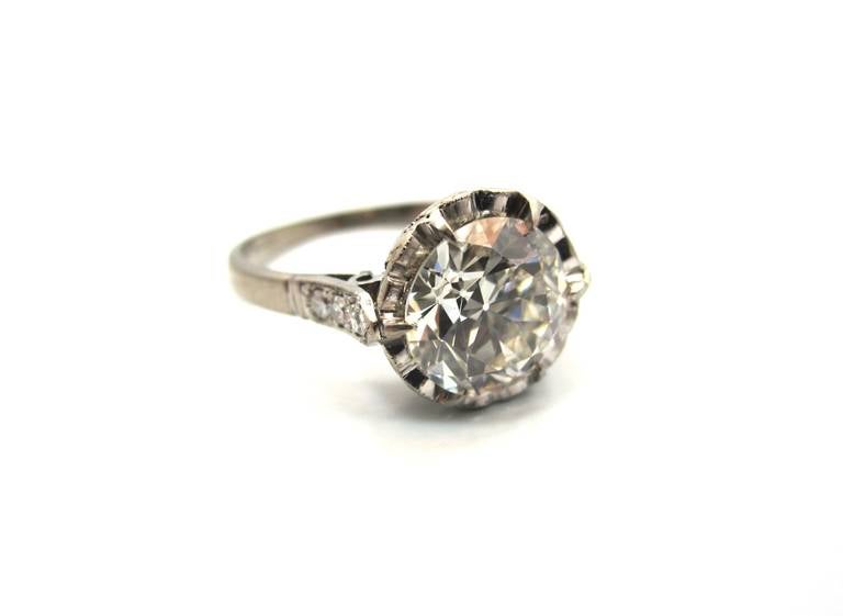 Elegantly handcrafted in 18 karat white gold this Edwardian era engagement ring (circa 1915) features a center stone 2.06 Carat Old European Cut diamond. Delicately prong set in a 