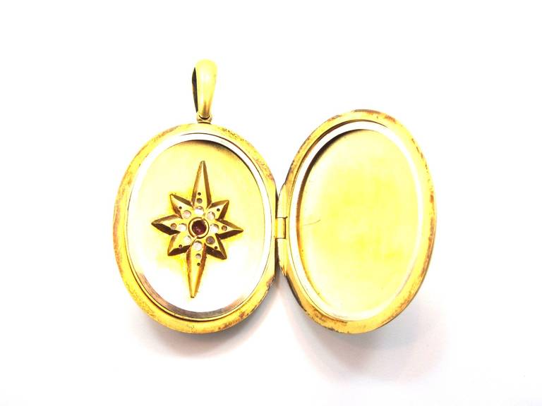 A fine example of a Victorian era pendant locket. Composed of 15 karat yellow gold. 18 Rose Cut diamonds set in a 