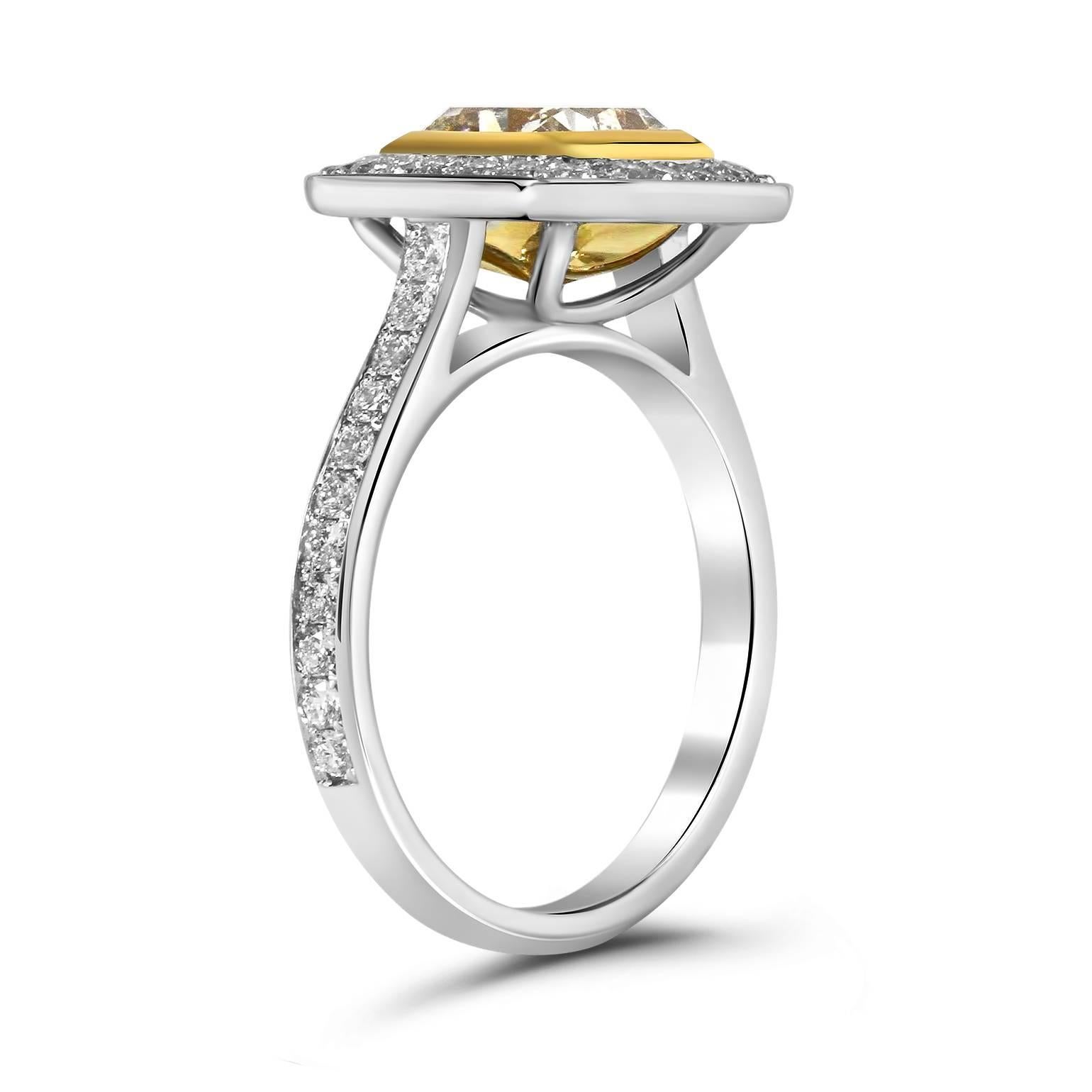 We present this striking, Diamond Engagement Ring skillfully crafted from 18K two tone gold symbolizing everlasting love and commitment!

The center stone carried on this piece is a 1.65ct EGL Certified Radiant cut diamond with Fancy Yellow color