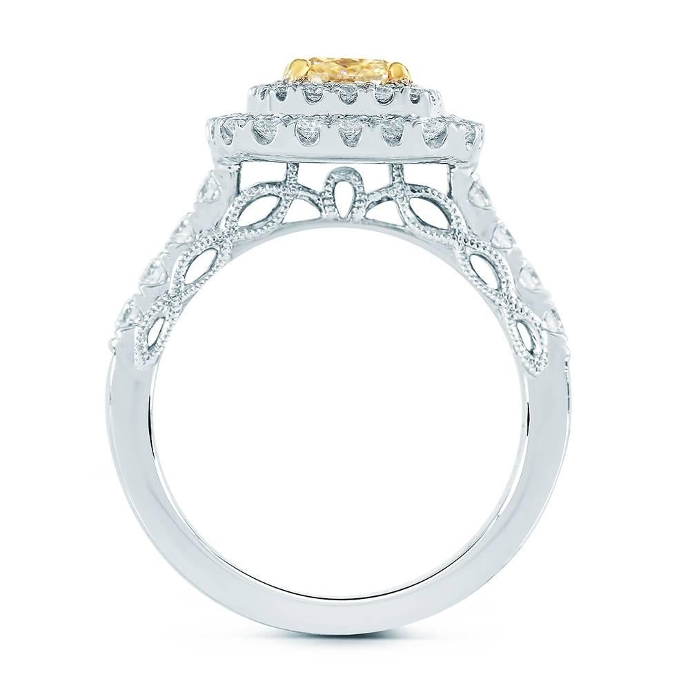 We present this striking, Diamond Engagement Ring skillfully crafted from 18K two tone gold symbolizing everlasting love and commitment!

The center stone carried on this piece is a 1.31ct EGL Certified Cushion cut diamond with Fancy Intense