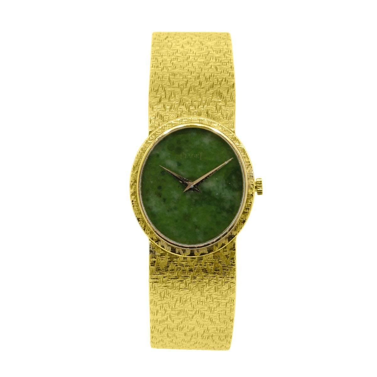 Brand: Piaget
Style: 18k Yellow Gold Jade Stone Dial Ladies Watch
Case Material: 18k Yellow Gold
Dial: Green Jade stone dial
Bezel: 18k Yellow Gold bezel
Case Measurements: 25mm X 27mm
Bracelet: 18k Yellow Gold
Clasp: Jeweler's Clasp
Movement: Hand