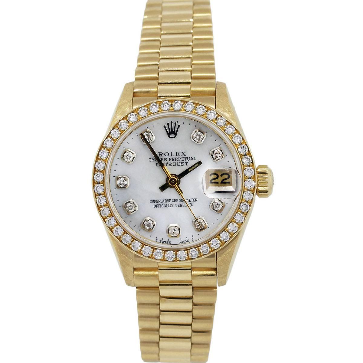 Brand: Rolex
Model: Datejust 6917
Case Material: 18k Yellow Gold
Dial: Mother of Pearl Dial with Aftermarket Diamond Markers
Bezel: Aftermarket Diamond Bezel, Diamonds are G in color and VS in clarity
Case Measurements: 26mm
Serial: 8
