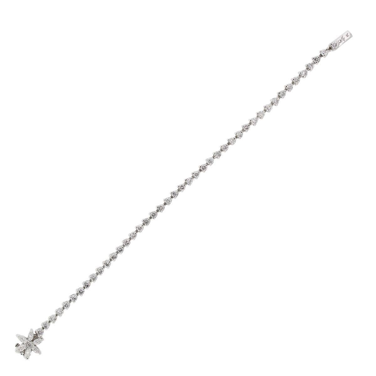 Material: Platinum
Diamond Details: Approximately 2.50ctw of round brilliant diamonds and baguette shape diamonds. Diamonds are G/H in color and VS in clarity.
Clasp: Tongue in box Clasp
Total Weight: 12.8g (8.3dwt)
Measurements: will fit up to a 6