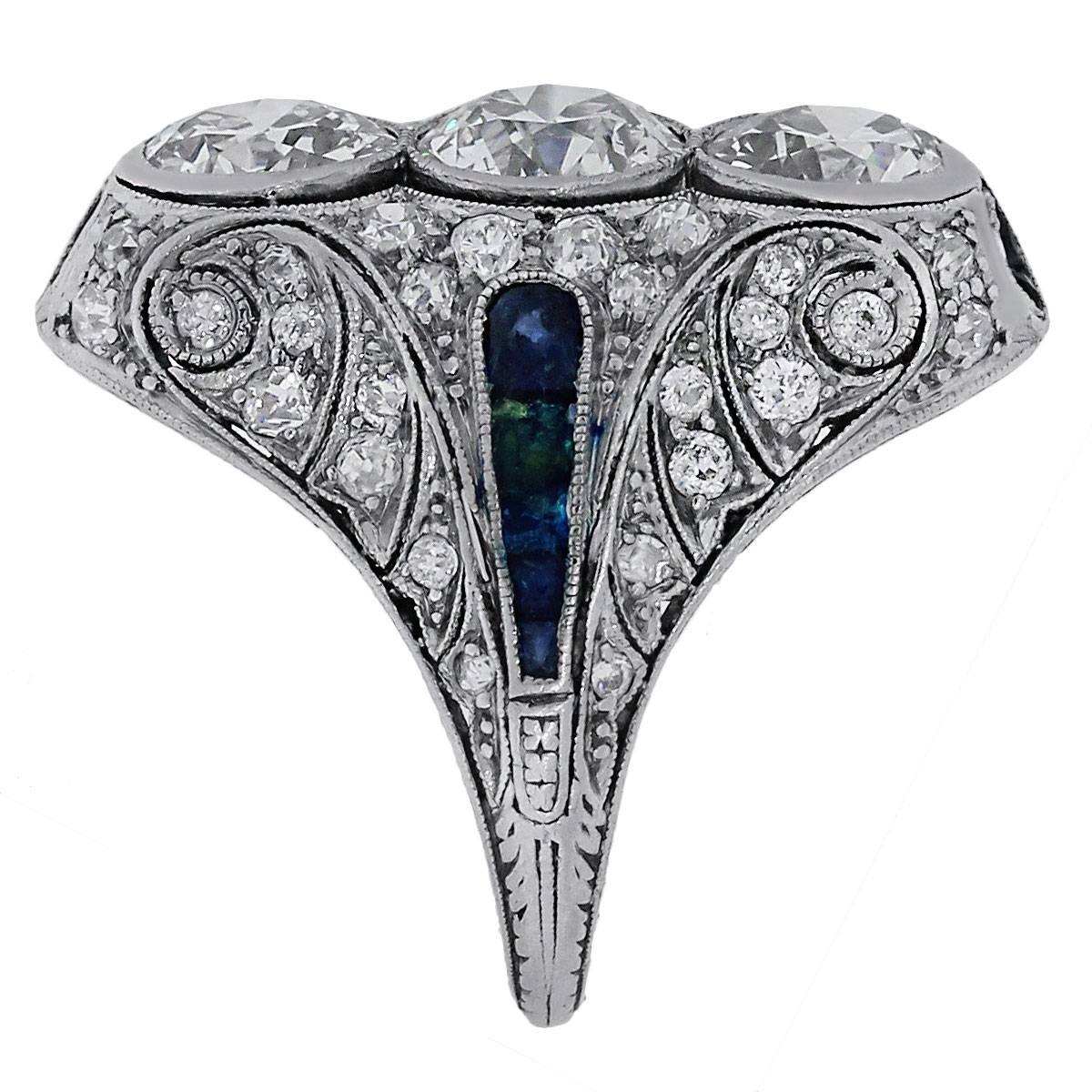 Material: Platinum
Diamond Details: Approximately 4.80ctw old European cut diamonds. Diamonds are H-I in color and VS in clarity.
Gemstone Details: Blue sapphires approximately 3mm in diameter
Ring Size	7.5 (can be sized)
Ring Measurements: 1.20