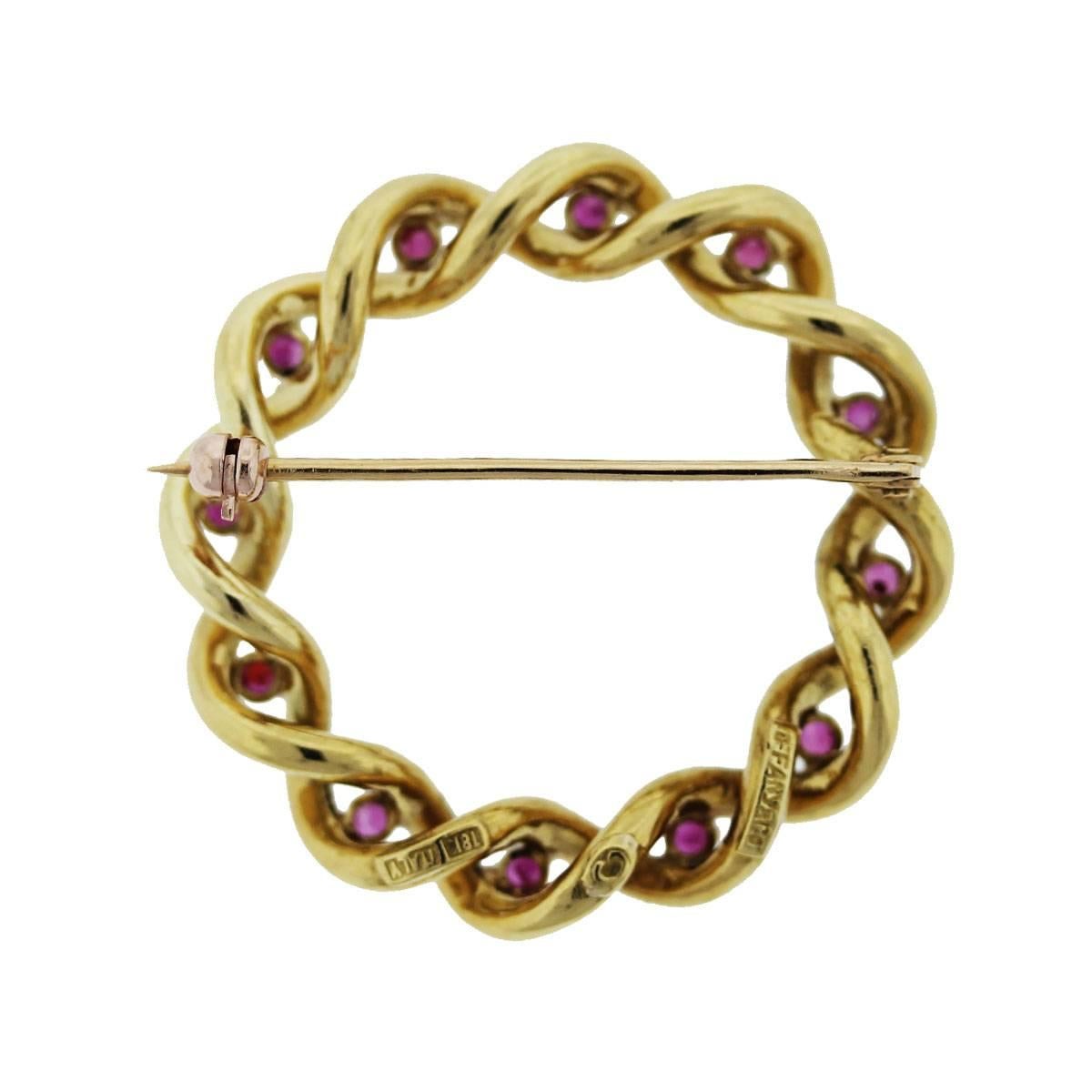 Style: Tiffany & Co. 18k Yellow Gold Ruby Wreath Pin
Material: 18K Yellow Gold
Gemstones: 12 Round Ruby Gemstones
Measurements: 1.25''
Total Weight: 7g (4.5dwt)
Additional Details: This item comes with a presentation box!