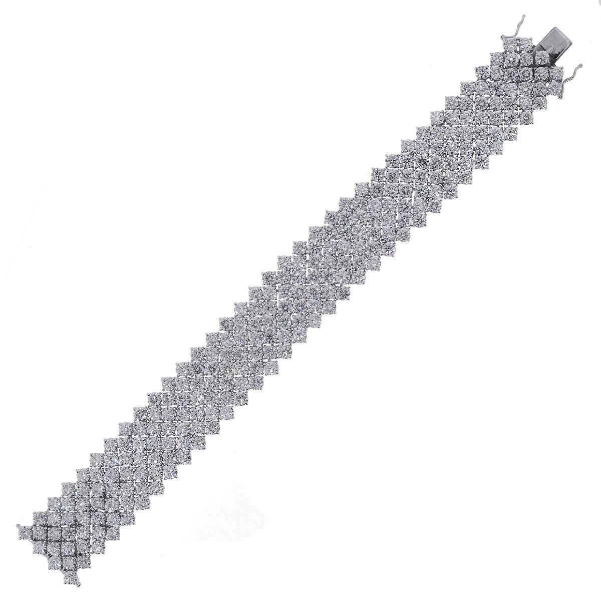 Material: 18k White Gold
Style: Multi Row Diamond Bracelet
Diamond Details: 239 diamonds approximately 46.6ctw round brilliant diamonds. Diamonds are F/I in color and VS in clarity.
Clasp: Tongue in box Clasp
Total Weight: 66.0g