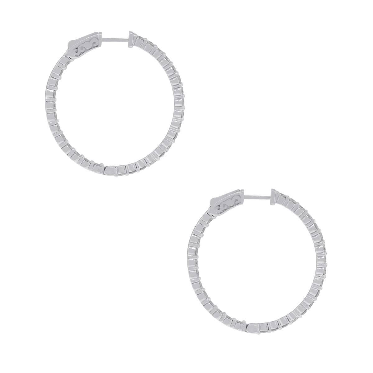 Material: 14k white gold
Style: Inside out diamond hoop earrings
Diamond Details: 58 round brilliant diamonds approximately 3.15ctw of round brilliant diamonds. Diamonds are G/H in color and VS in clarity.
Measurements: 1.40