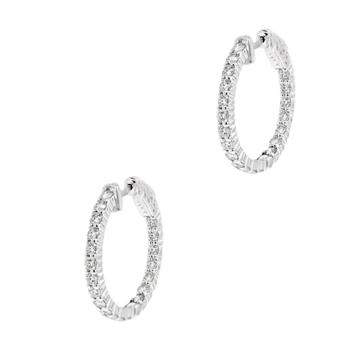 Material: 14k white gold
Style: Inside out diamond hoop earrings
Diamond Details: 40 round brilliant diamonds approximately 1.70ctw of round brilliant diamonds. Diamonds are G/H in color and VS in clarity.
Measurements: 0.96