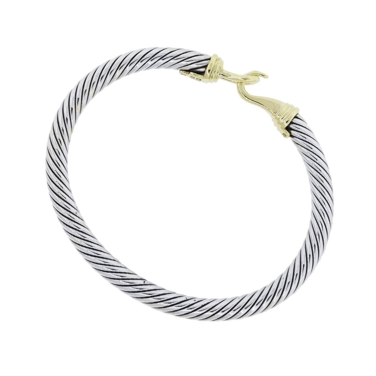 Designer: David Yurman
Material: Sterling silver and 14k yellow gold
Clasp: Hook
Total Weight: 28.9g (18.6dwt)
Bracelet Measurements: 2.5″ x 0.19″ x 2.25″. Will fit a 6″ wrist.
Additional Details: Item comes complete with a Raymond Lee Jewelers