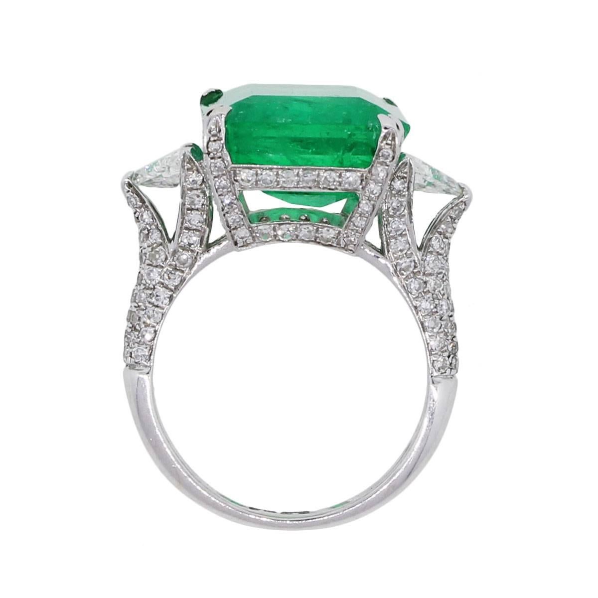 Material: 18k white gold
Diamond Details: Approximately 3.62ctw of trillion shape diamonds and round brilliant diamonds.
Gemstone Details: Approximately 14.22ct emerald shape emerald measuring approximately 16.23mm x 12.57
Ring Size: 6.25 (can be