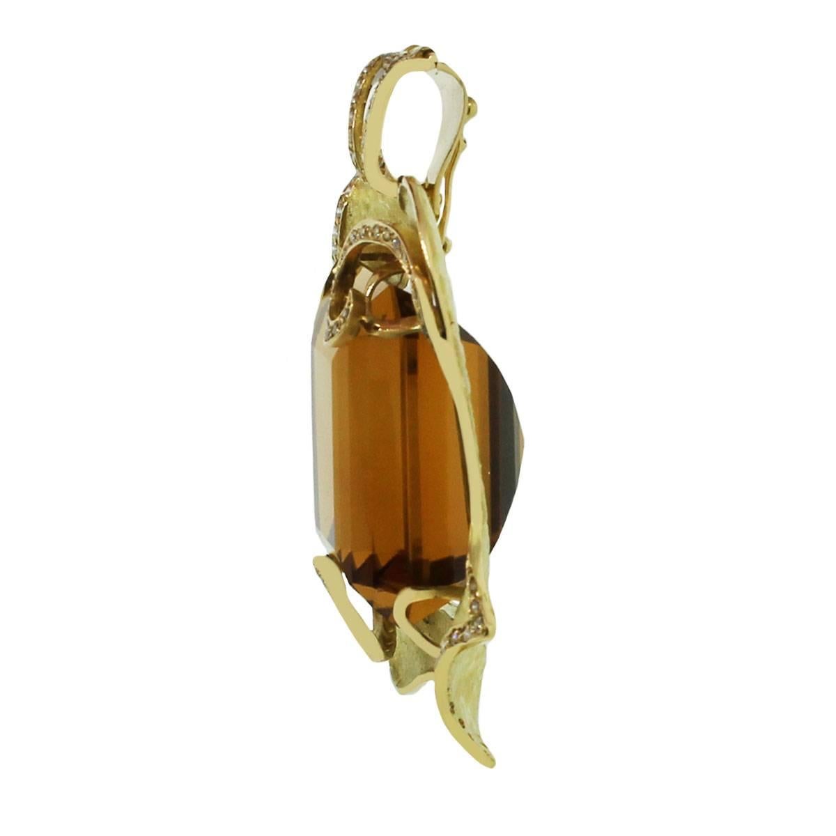 Style: Citrine pendant
Material: 18k Yellow Gold
Diamond Details: Approximately 1ctw round brilliant diamonds. Diamonds are G/H in color and VS in clarity
Gemstone Details: Approximately 115.91ct emerald cut citrine gemstone
Pendant Size: 2.10″ x