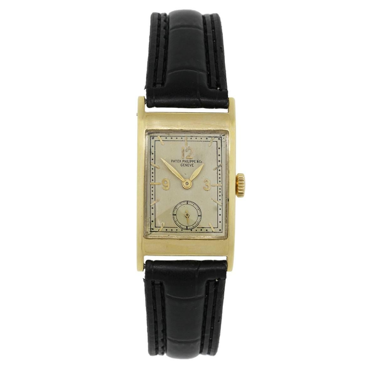 Brand: Patek Philippe
Case Material: 18k 
Case Diameter: 21mm
Bezel: Smooth 18k yellow gold
Dial: Silvered dial with sub dial at the 6 o’clock position
Bracelet: Black leather strap
Crystal: Plastic
Size: 7.50″ in length
Clasp: Stainless steel tang