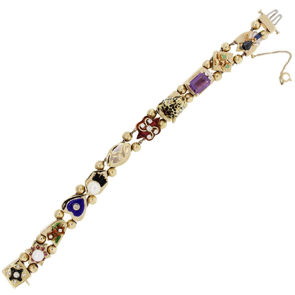 Material: 14k yellow gold
Diamond Details: Approximately 0.68ctw of round brilliant diamonds.
Gemstone Details: Pearl, enamel, onyx, emerald, amethyst, sapphire
Fastening: Double tongue in box clasp with safety chain
Measurements: Will fit a 7″