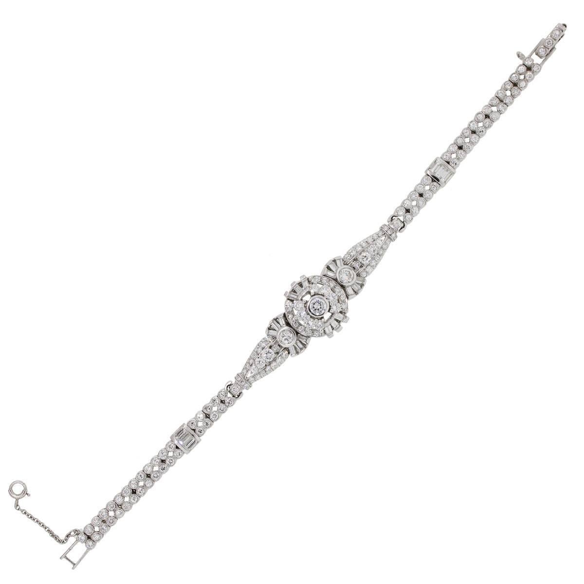 Material: Platinum
Diamond Details: Approximately 6.09ctw of baguette and round shape diamonds. Diamonds are G/H in color and VS in clarity
Fastening: Jewelers’ clasp with safety chain
Measurements: Will fit a 6.75″ wrist
Item Weight: 25.5g