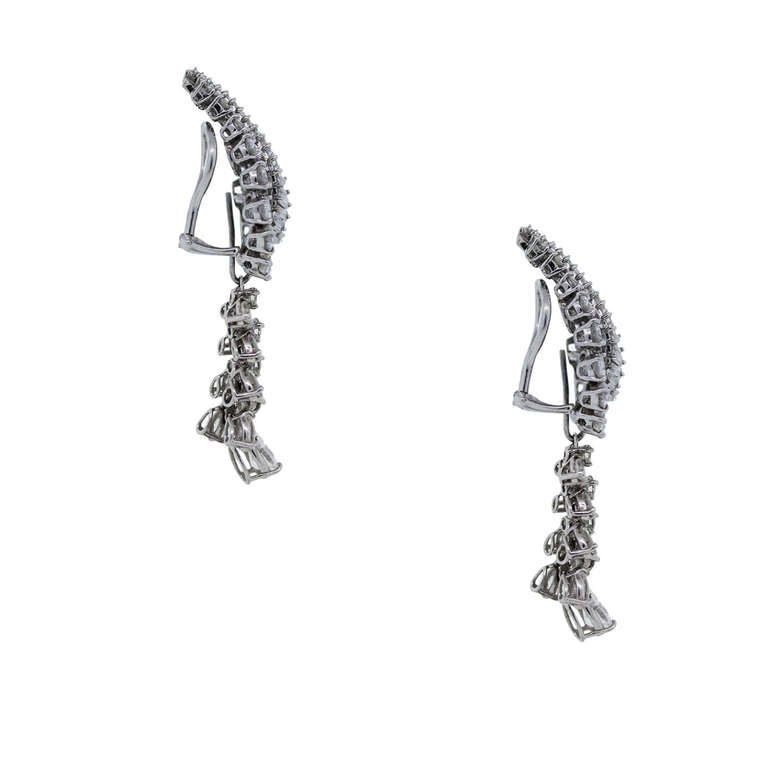 Metal: Platinum
Diamonds Details: Approximately 9ctw. G/H in color and VS in clarity.

Backs: Clip-On (Omega Non-pierced)
Item Weight: 12.5dwt (19.5g)
Earring Measurement: 2.12