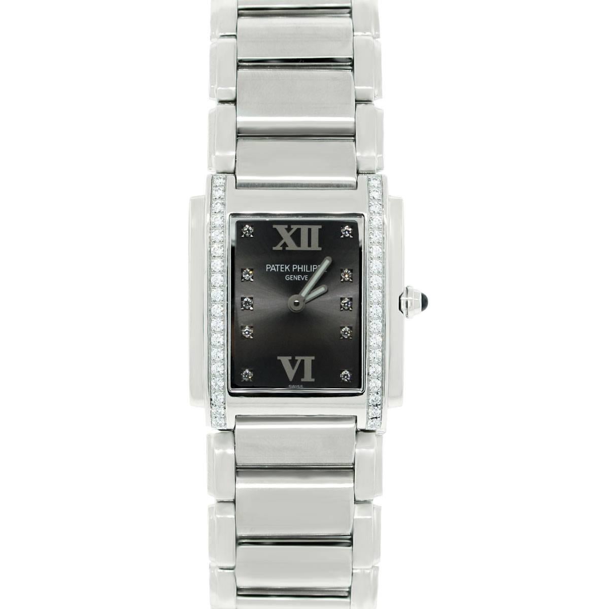 Brand: Patek Philippe
Model: Twenty 4 4910/10A-010
Style: Dress
Material : Stainless Steel
Dial: Gray dial, diamond hour markers and gold Roman numerals at 12 and 6 o'clock; with silver luminescent hands
Bezel: Smooth, Fixed Stainless Steel