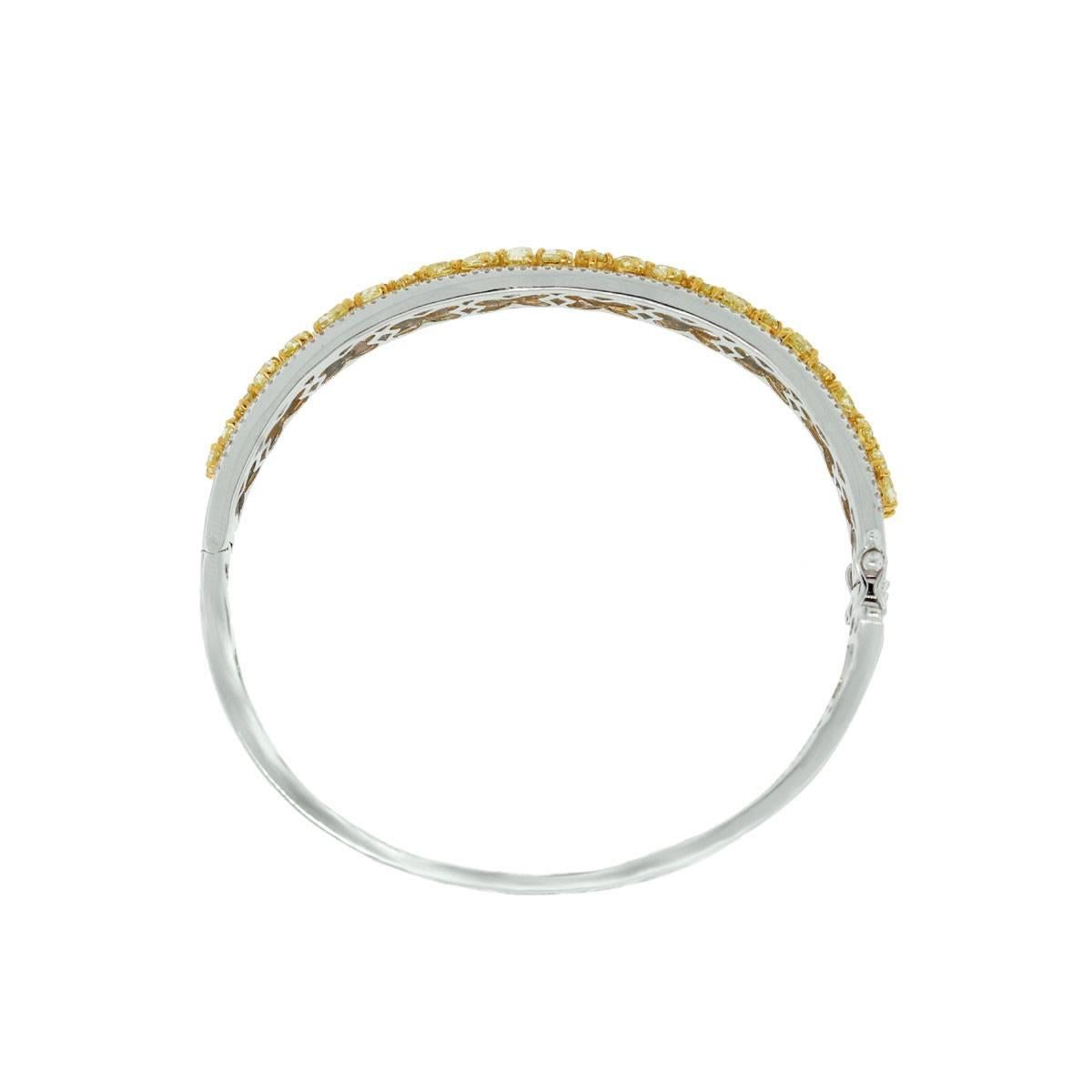 Style- 18k White Gold 5.53ctw Fancy Yellow Diamond Bangle
Material- 18k White Gold with 18k Yellow Gold setting
Diamond Details- Approximately 5.53ctw of Fancy Yellow Diamonds. Diamonds are natural in color and VS in clarity.  Approximately 0.93ctw
