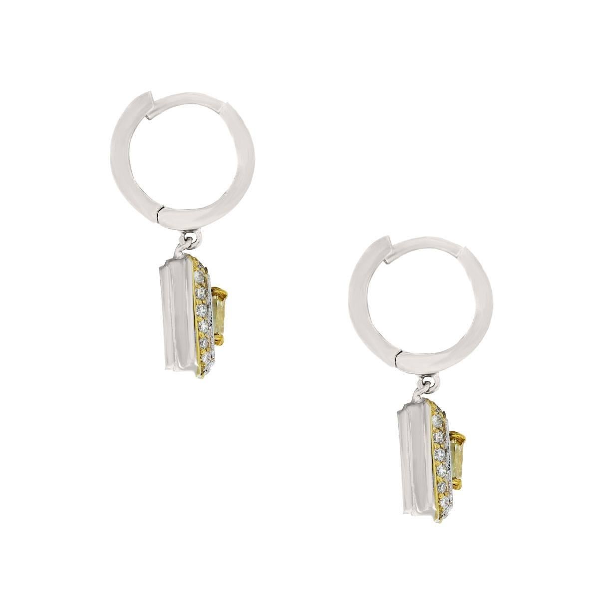 Style: 14k White Gold Fancy Yellow Cushion Diamond Dangle Earrings
Diamond Details: 2 Cushion Fancy Yellow Diamonds approximately 1ctw, diamonds are natural in color and VS in clarity.  Approximately 0.70ctw of Round Brilliant Diamonds, diamonds