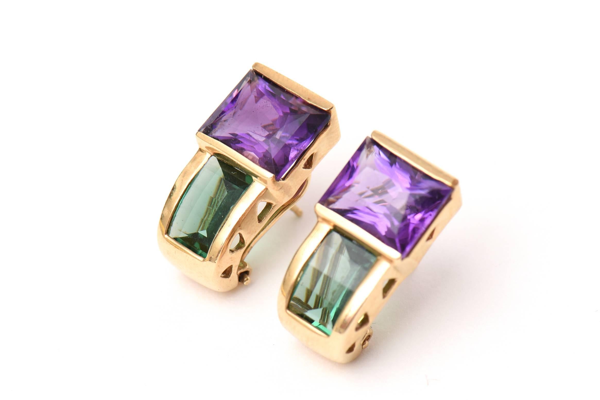 These lovely yet small pierced pair of jewel toned earrings are green tourmaline and amethyst with 14k gold which are a beautiful combination of colors perfect for the all seasons. Day or night. They are small and fit like a stud earring.
The are