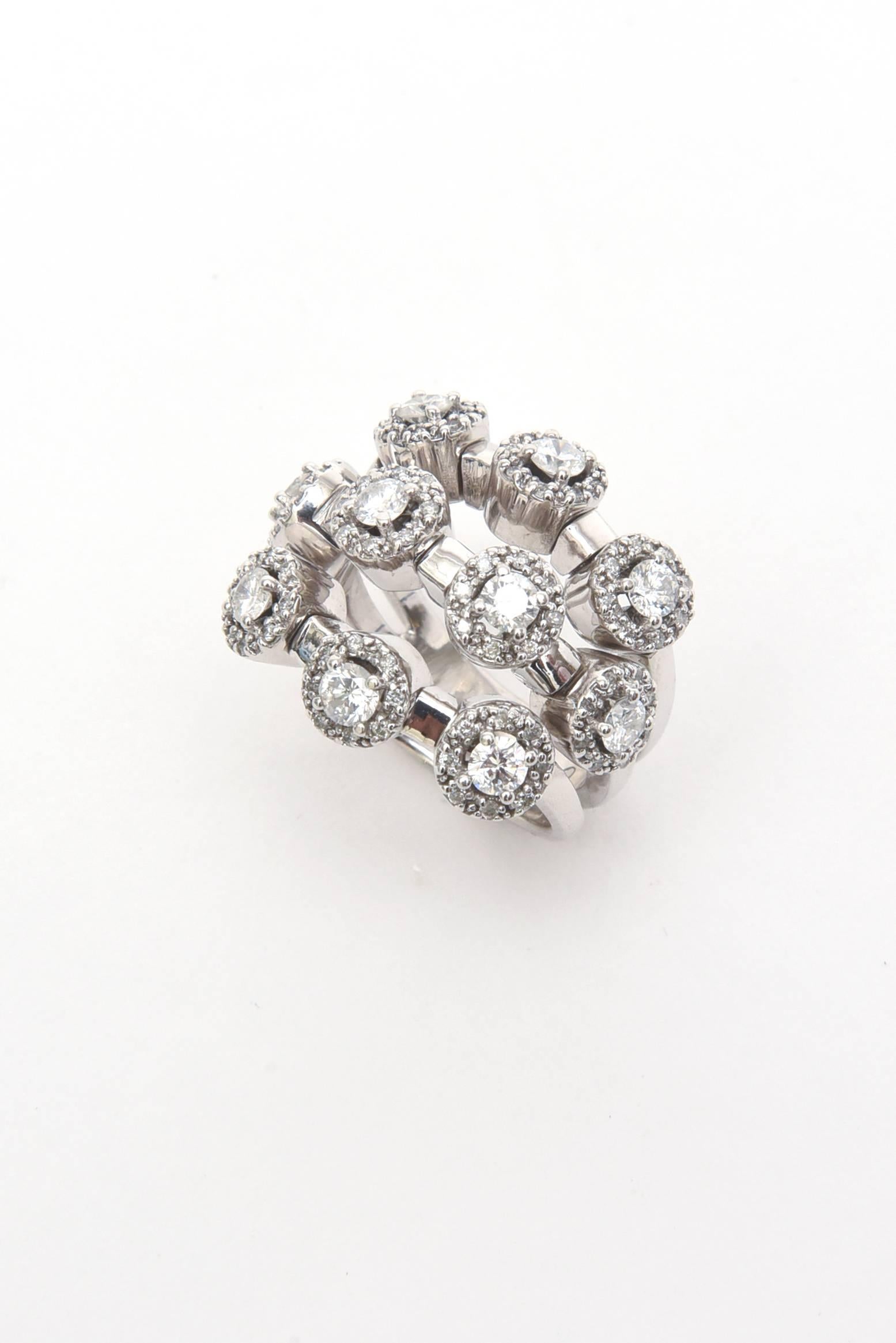 This arresting and stunning 14 Karat white gold diamond trembler ring has 3 connected rows consisting of 80 smaller diamonds of .40 in carat weight which are GH color. The 10 bigger diamonds that surround are 12 points each which equals 1.20 carat
