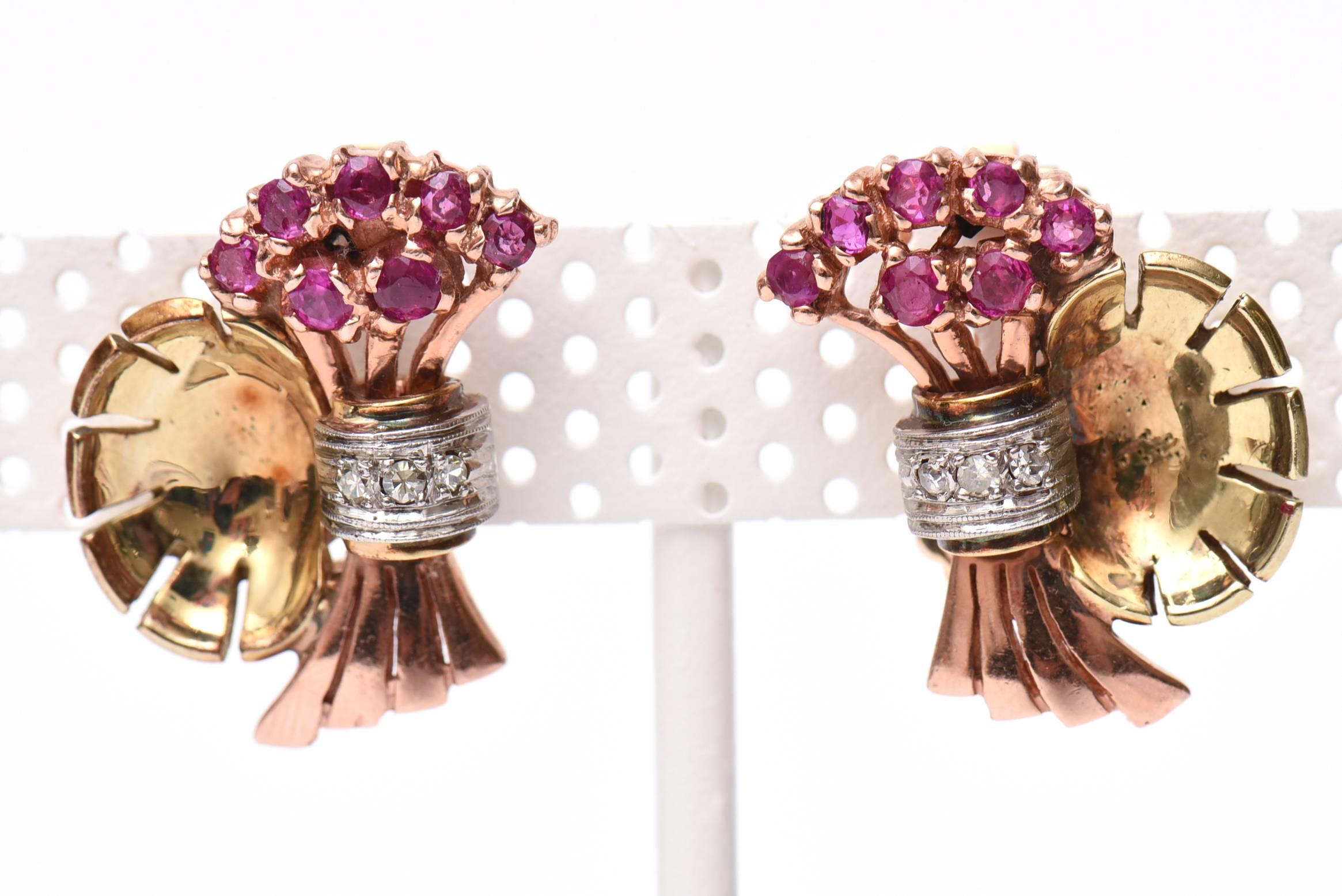 These lovely pair of 1940's clip on earrings have 14 round rubies and 6 single cut round diamonds. They are a combination of rose gold and 14K yellow gold.
The flower like form is beautiful.
They are 11.7DWT