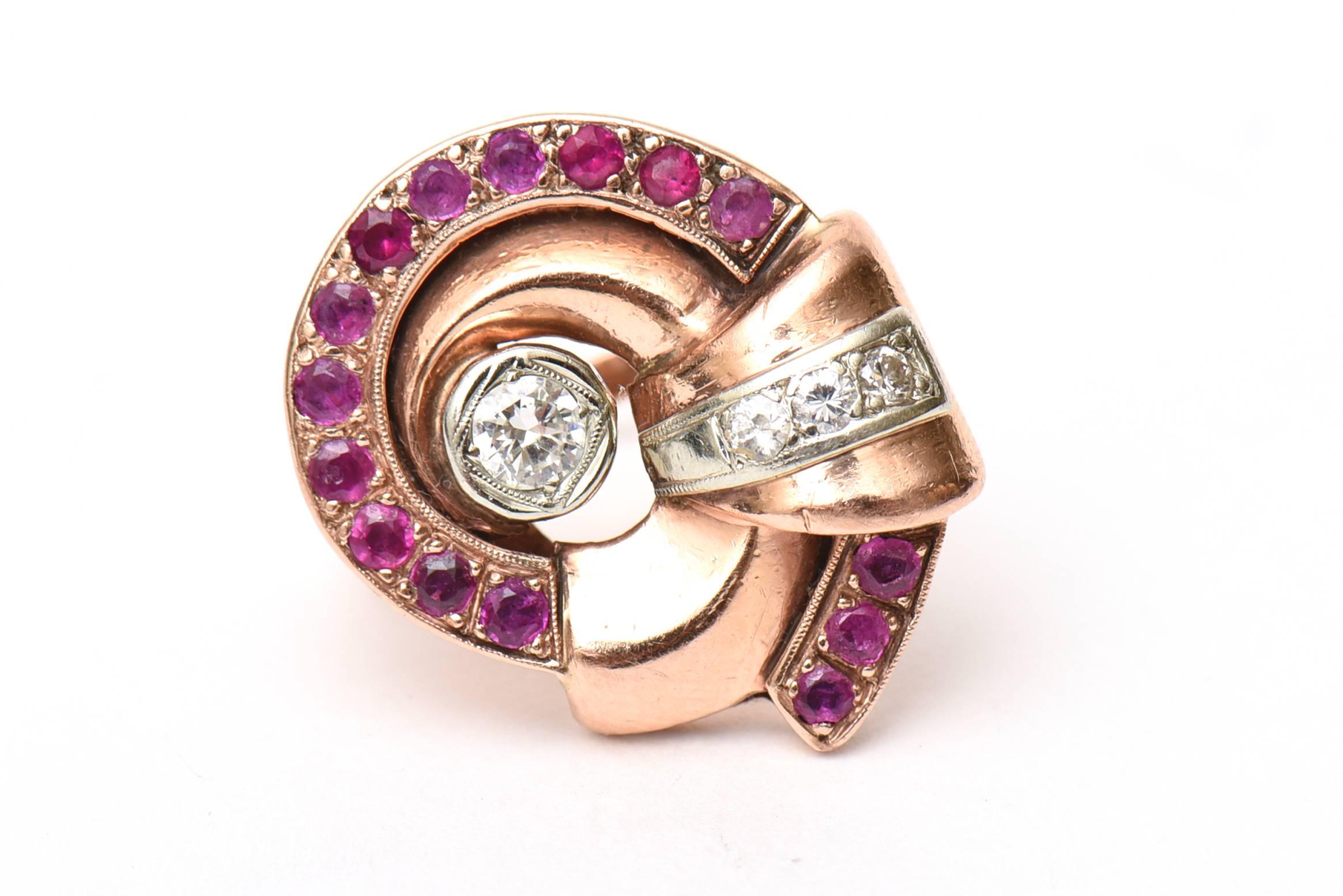 This lovely 1940's circular design retro ring has 15 round rubies with 4 diamonds set in rose gold on the side. The center stone is a .25 carat round diamond. the smaller diamonds are .35 carat in diamonds.
The weight is 7.3 DWT. it is marked